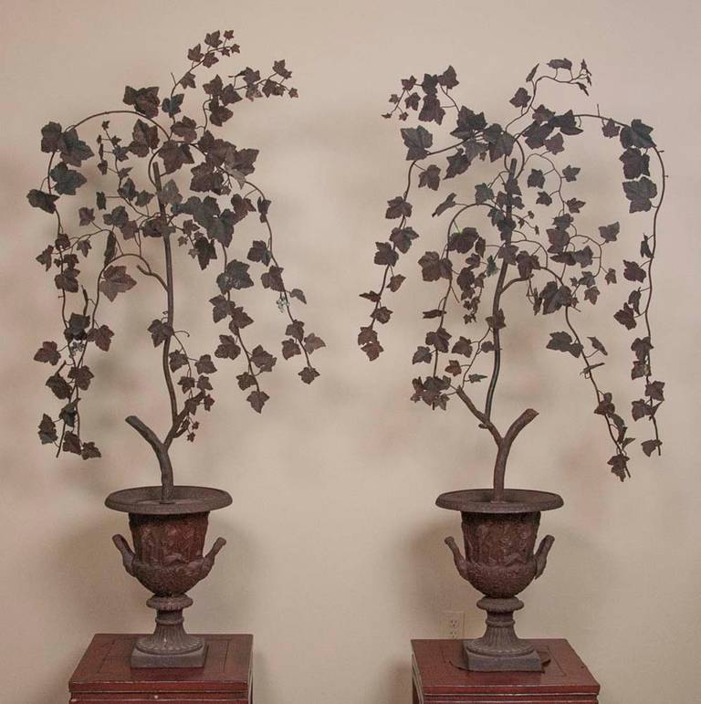 A beautifully made pair of ornamental expressions of grape leaves presented in cast iron pots.