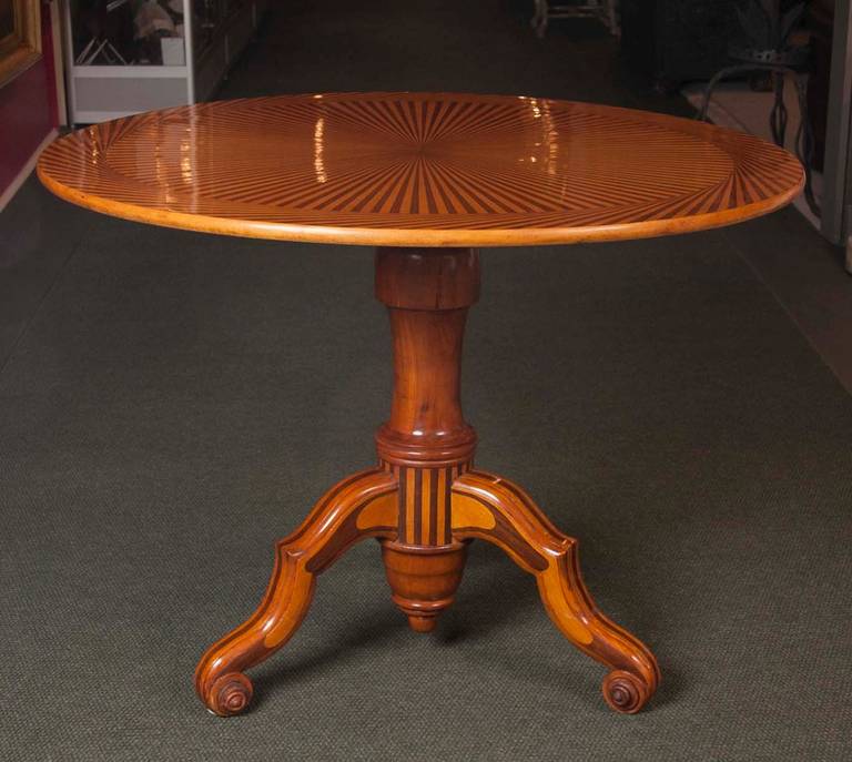 A continental parquetry tilt-top tea table with circular top. The table sits on a tripod base and contains some of the most magnificent parquetry of its time.