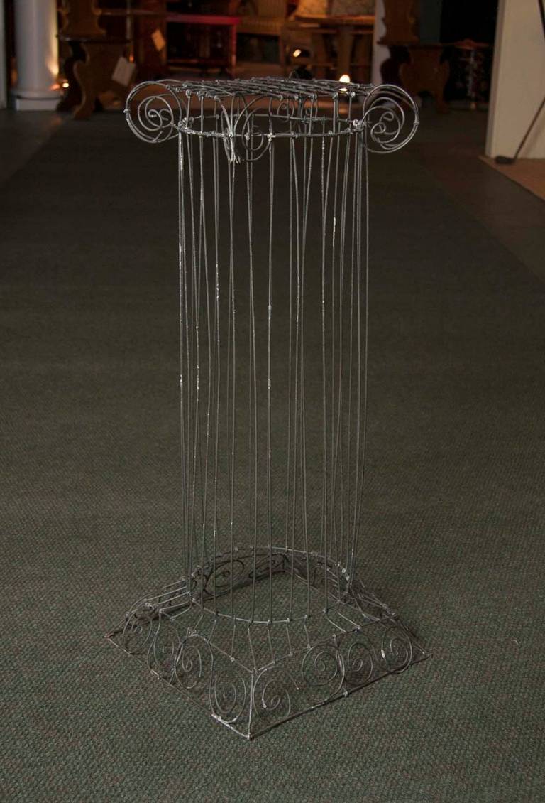 An amusing classic ionic form wire column possibly a plant stand. American.