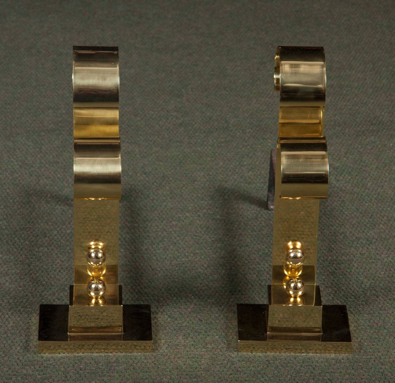 A pair of midcentury polished brass andirons by Richard Neutra.