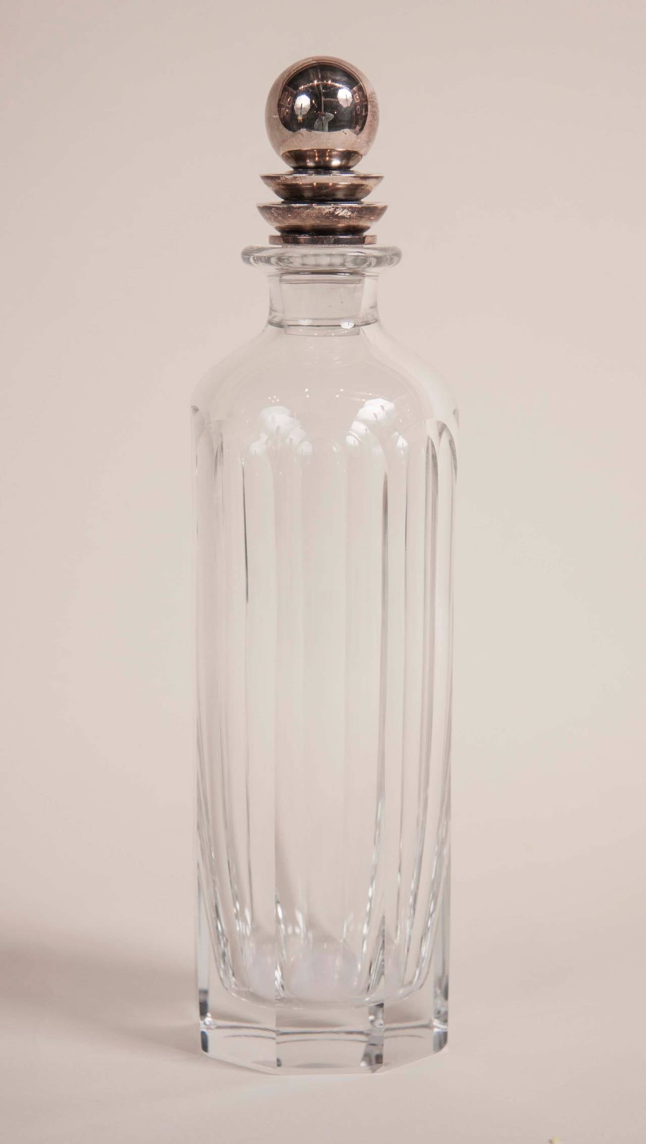 An Art Deco style crystal pyramid decanter with a silver top designed by Harald Nielsen in the first half of the twentieth century.