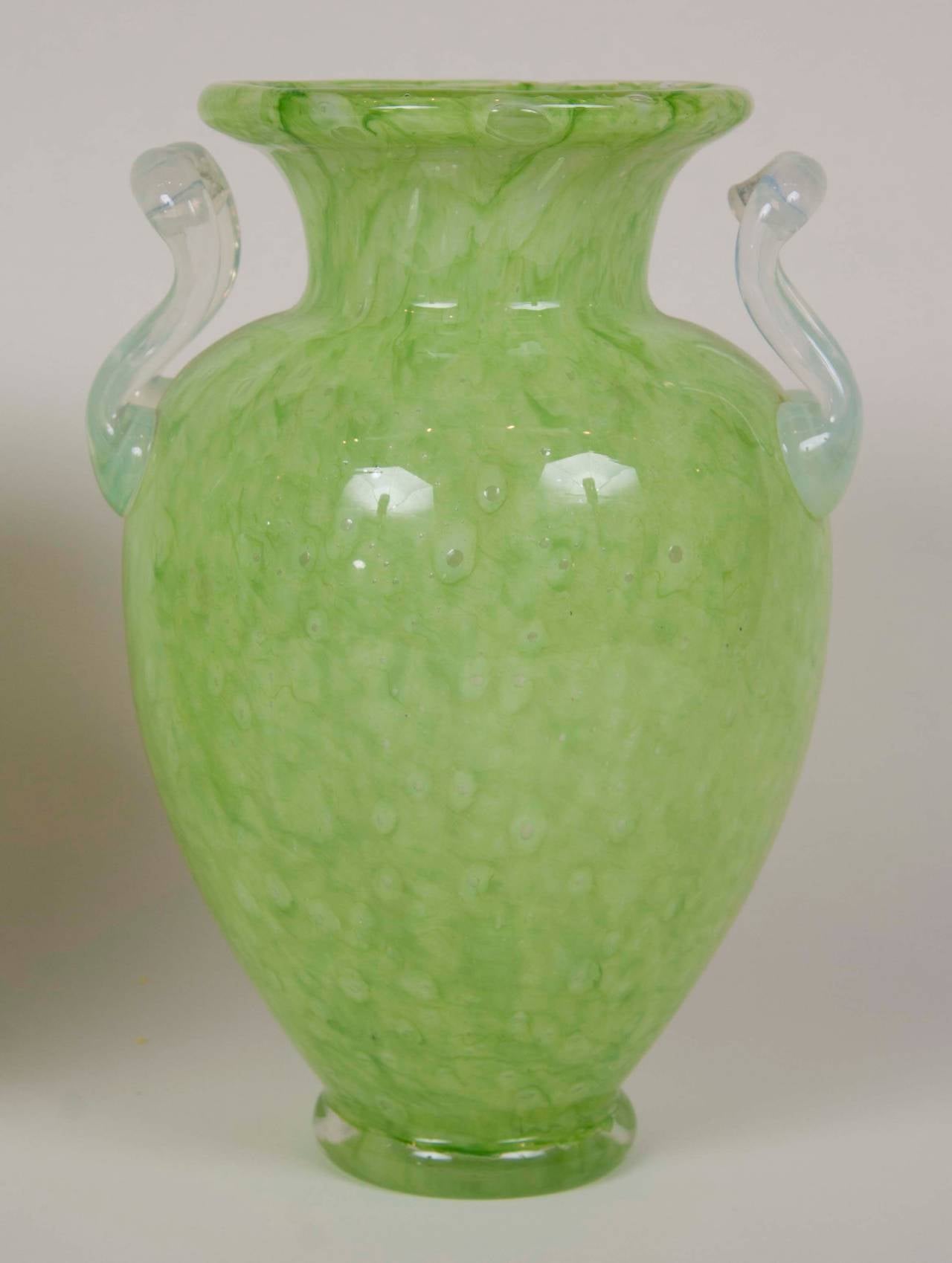 A pair of Steuben green cluthra glass vases with opaque handles by Frederick Carder.
