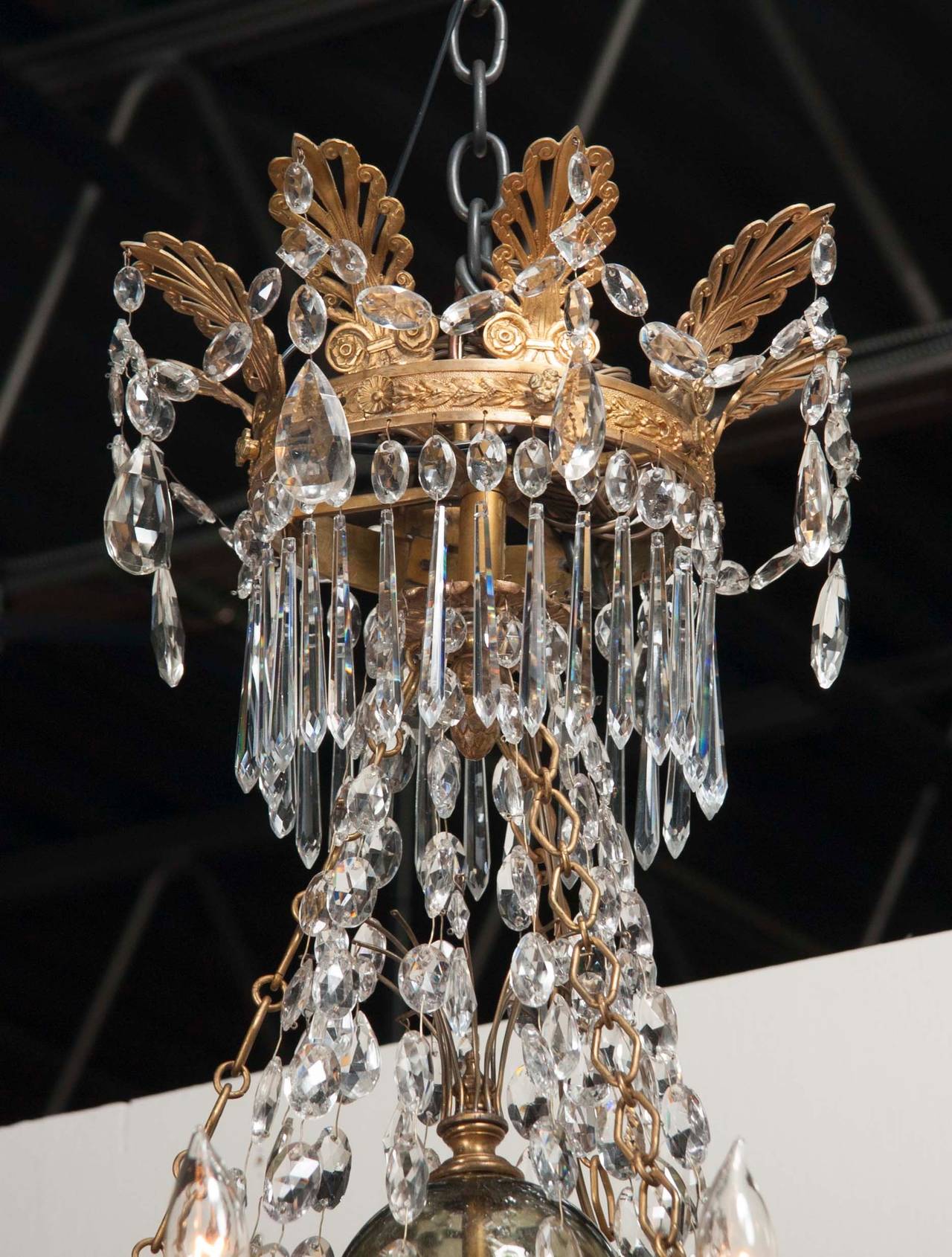 A twelve-light, fine quality, doré bronze, Russian neoclassical Empire chandelier with crystal drops.