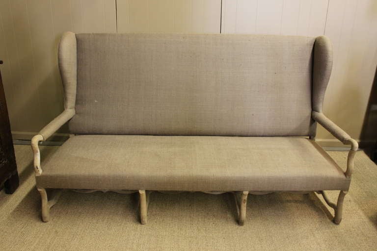 Handsome vintage Os de Mouton French sofa with wing back.  Wood arms and legs have a bleached finish.  Large deep seat.  Nubby linen upholstery.