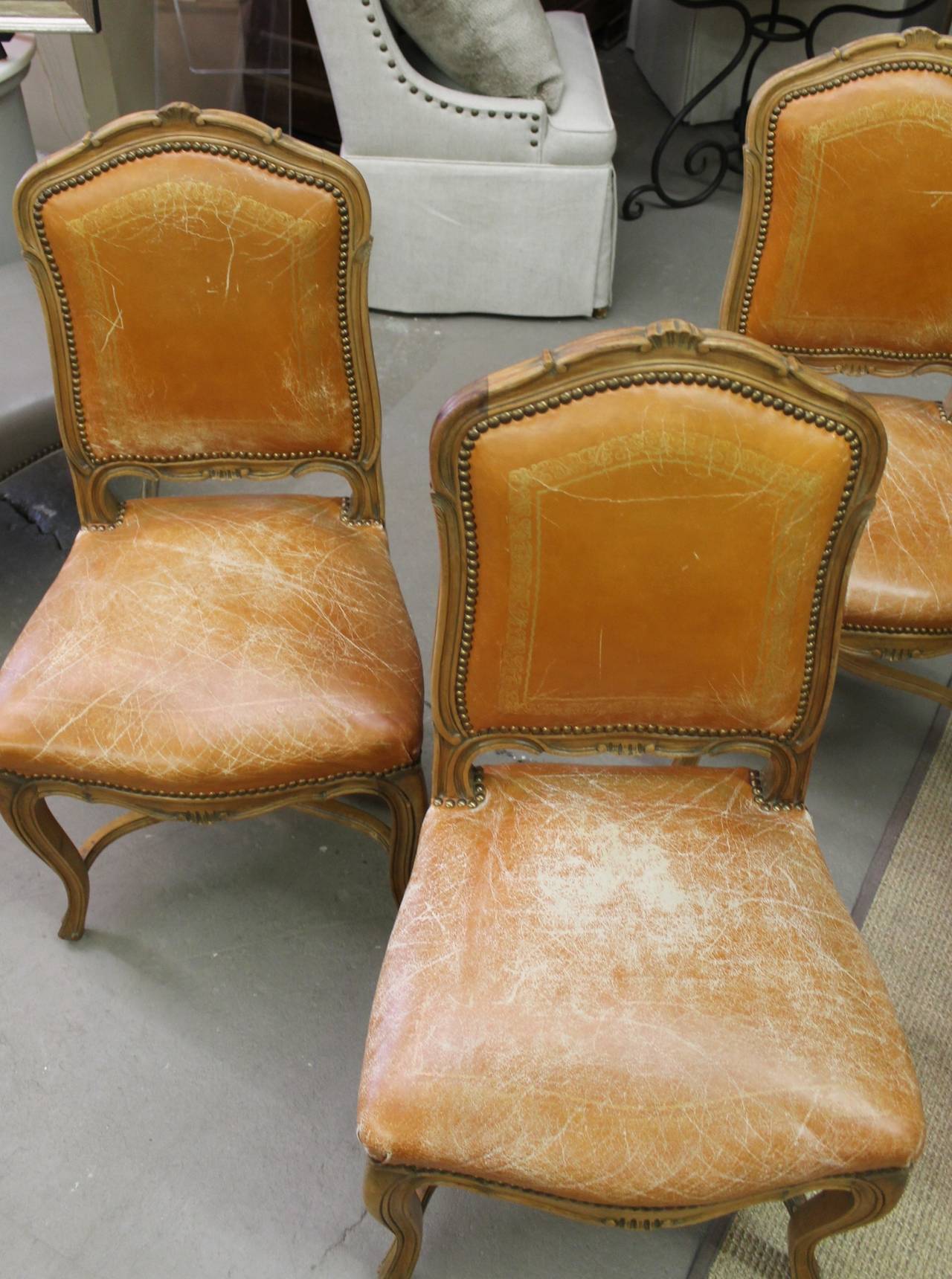 While the leather is worn its orange and fabulous, no holes. Gilt stamped design.