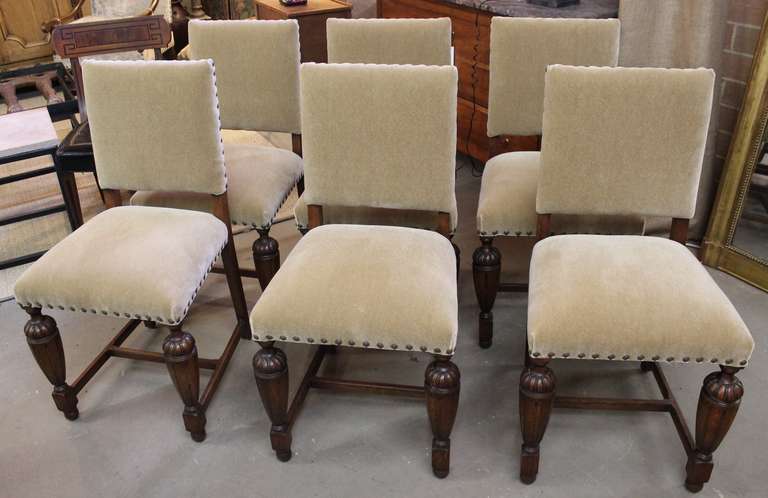 Charming set of 6 Tudor Dining chairs. Carved oak legs. Upholstered in neutral mohair on backs and seats with antique nailheads. Lots of personality!