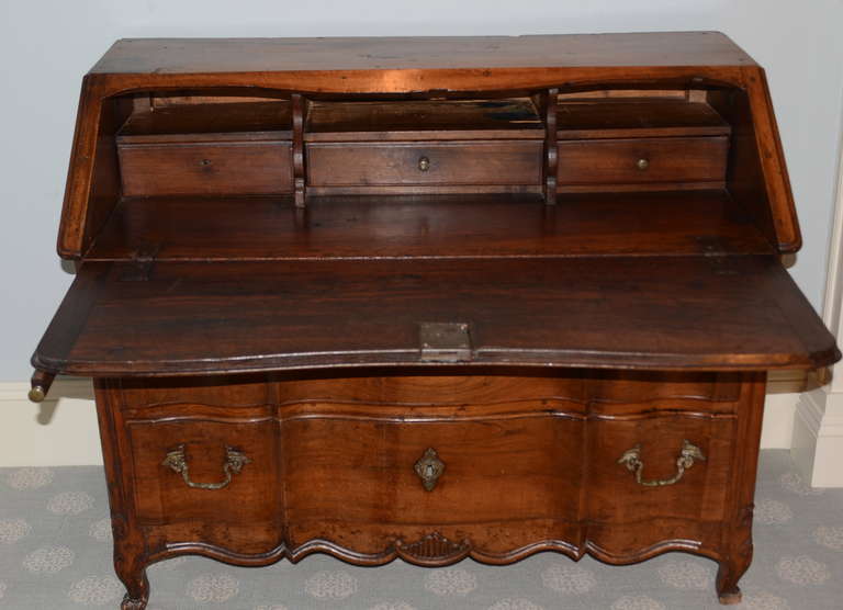 Lovely 18th century walnut secretary from Lyon, France. Beautiful arboreta two drawer front with carved apron and scalloped feet. Carved panel sides. Great aged patina. All original.