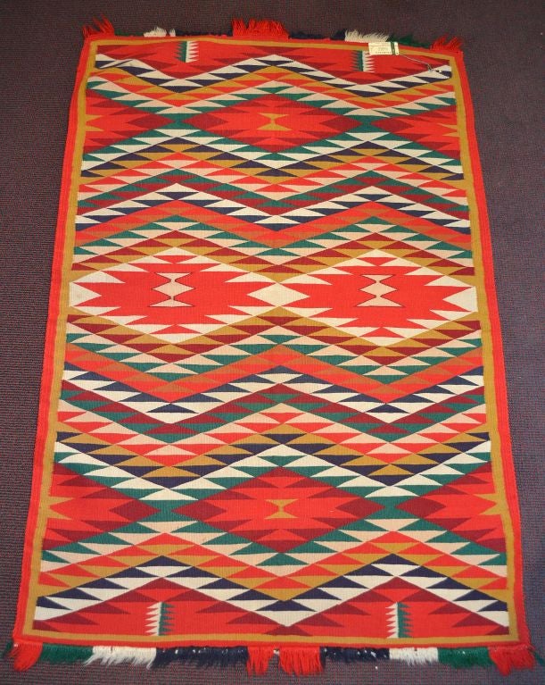 A beautiful tightly woven Navajo textile with vibrant colors and an exceptional weave.