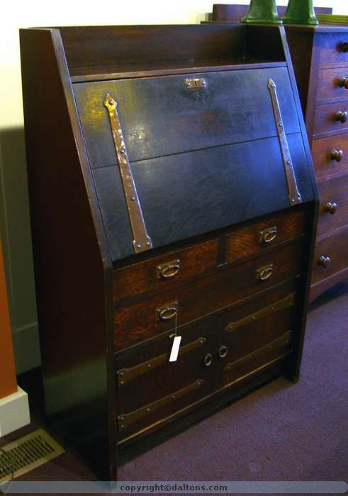 This early and desirable Gustav Stickley desk with strap hardware still retains its original surface.    Signed with the large red decal on the back.