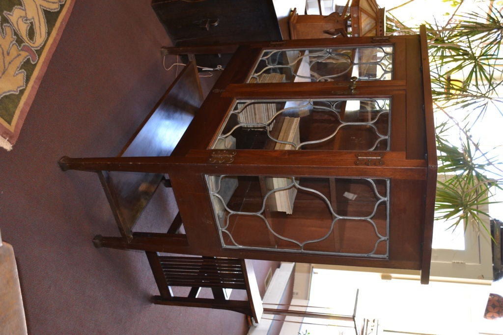 Rare leaded glass and Mahogany cabinet by Elbert Hubbard and the Roycrofters. Signed with the incised logo on front.