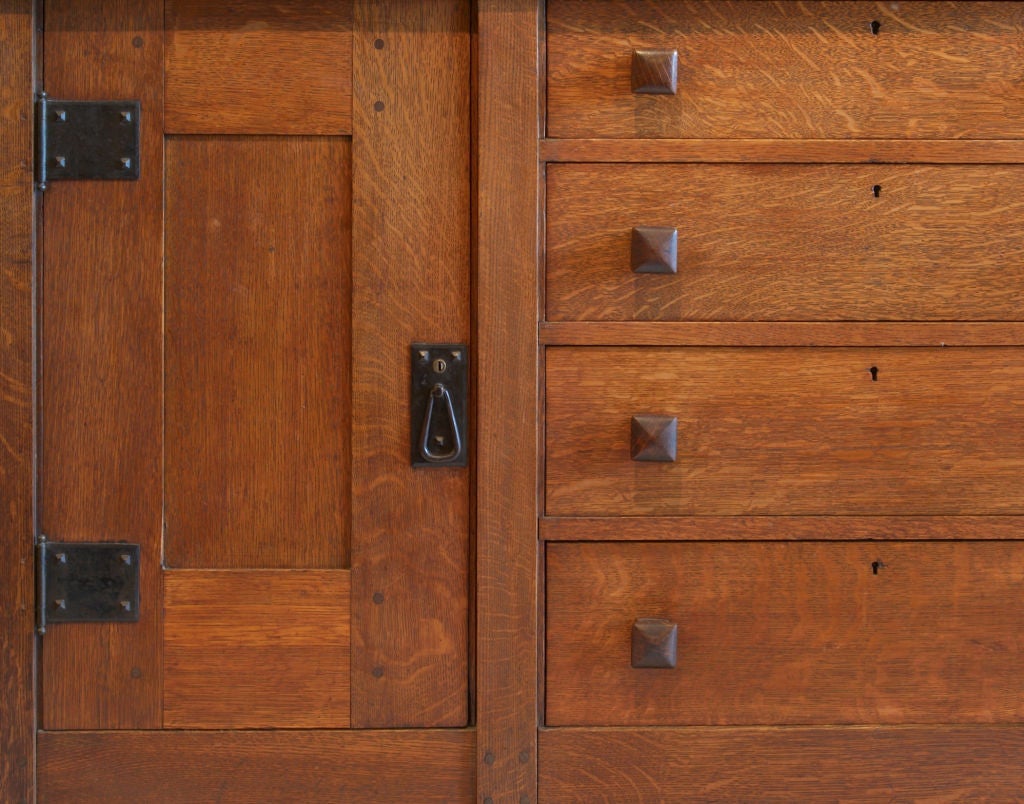 One of the earliest examples of a Gustav Stickley 8 leg sideboard. Unlike later versions this piece uses no veneer, all panels are solid oak. The hardware is hammered iron and have the original patina. Signed with the 1902 - 1903 decal.