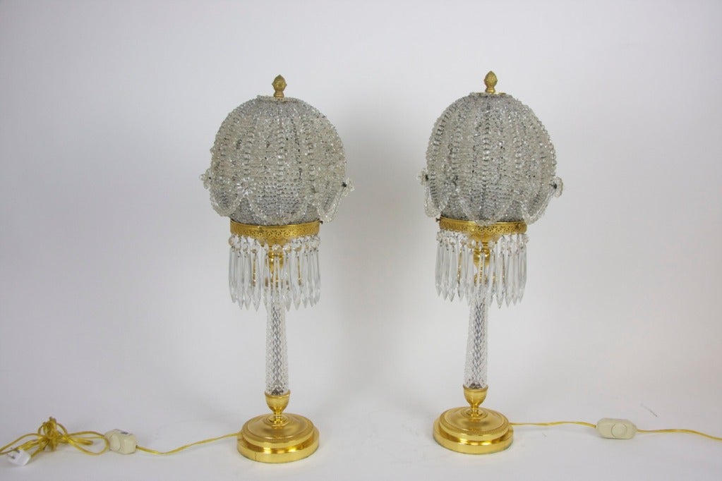 Pair of crystal and mercury gilded bronze table lamps with balloon-shaped shades 'en suite' by Jansen. They were created by Maison Jansen, the world's first global design firm. From their founding in 1880 until they closed in 1897, they created