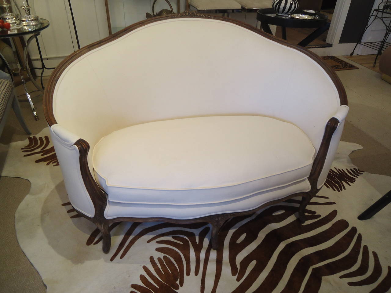 Adorable enveloping jewel of a canapé with lovely curves, new crisp white duck upholstery and down cushion, picture window back, pegged frame. 
 Seat height 14