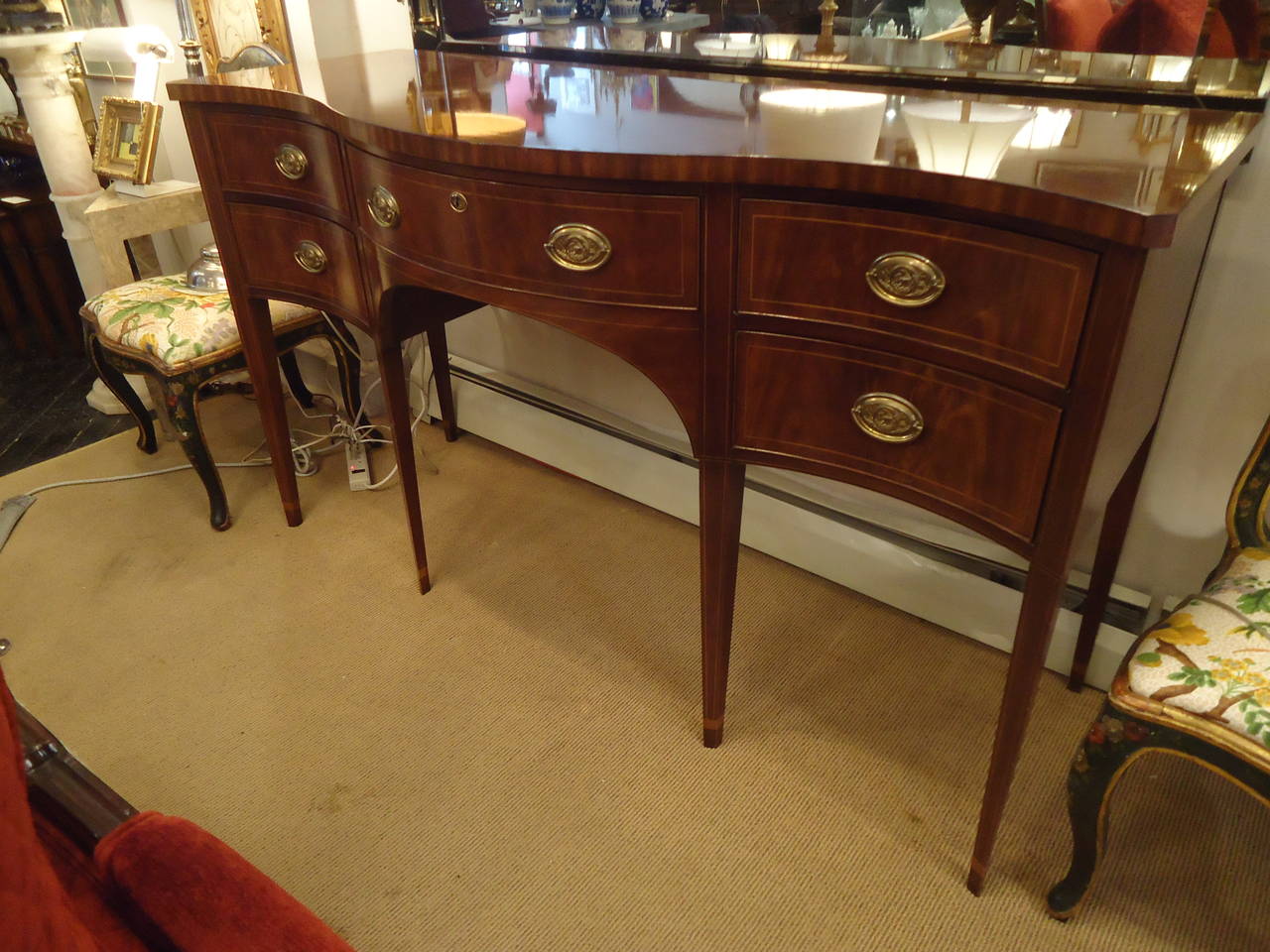 Mahogany sideboard with serpentine front and tapered legs modeled after an 18th century server in a private Charleston house. Top of the line Baker piece from their 