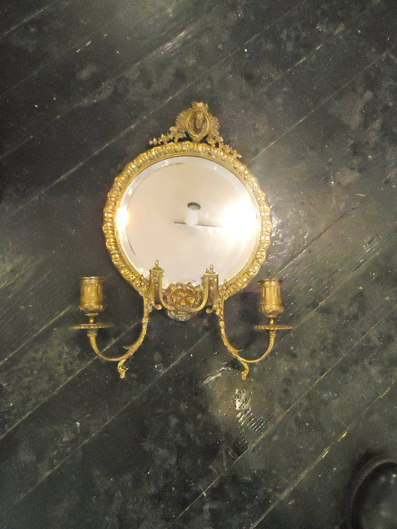 Each sconce has a round mirror framed in ornate brass with a lovely female face at the top and lion at the bottom, two curved arms extend from the mouth of the lion for candlelight. Marked on the backs, Tiffany.