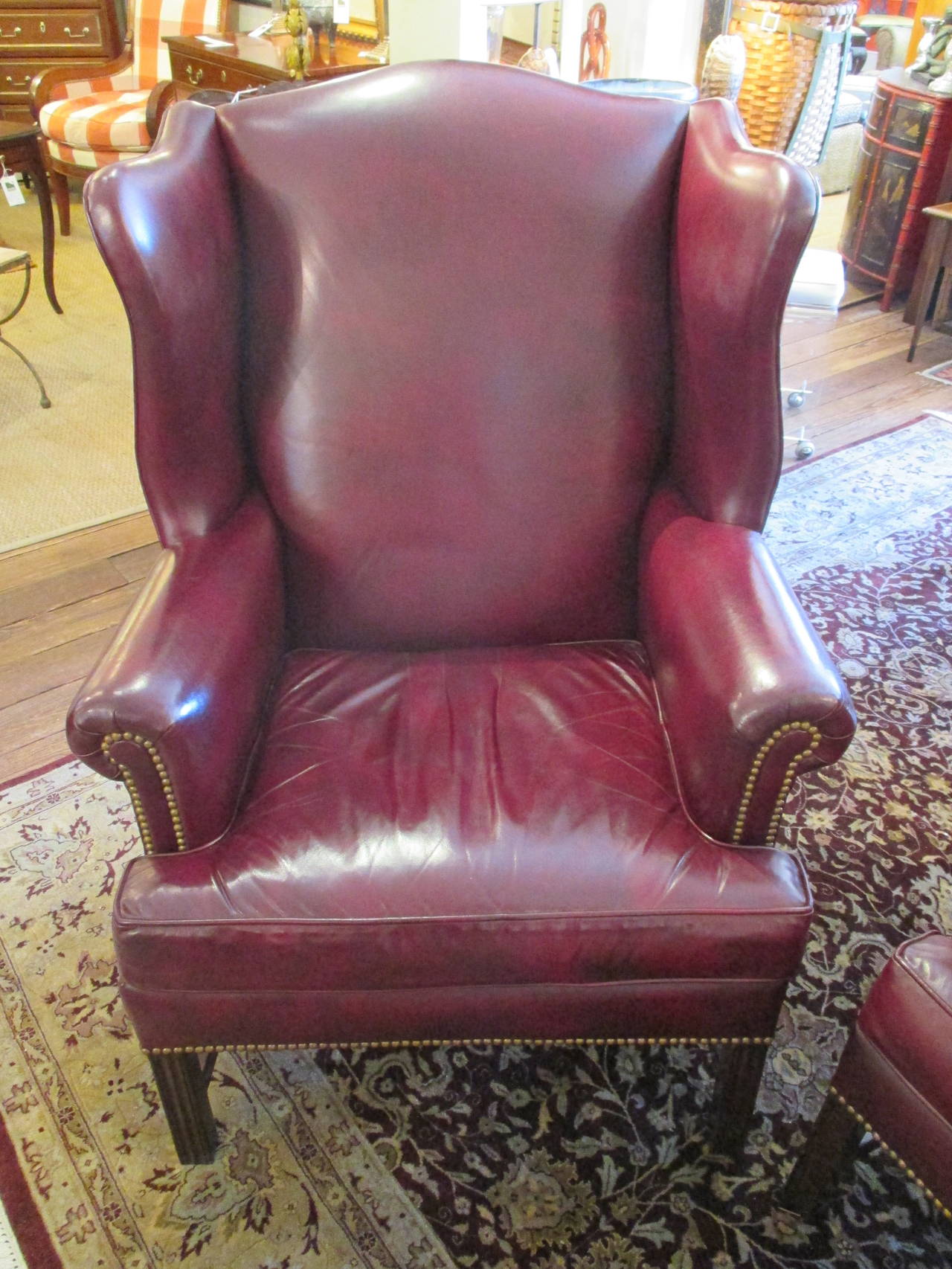 Supple cordovan wine colored leather with nailhead details, by Hancock and Moore. Comfortable and Classic wing chairs.
Dimension: Seat 20