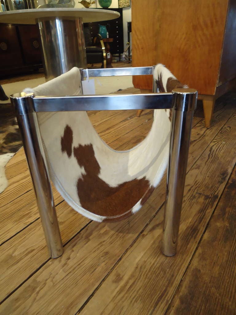The chrome frame is vintage.  Newly constructed with a piece of cowhide rug.
Great design and function.