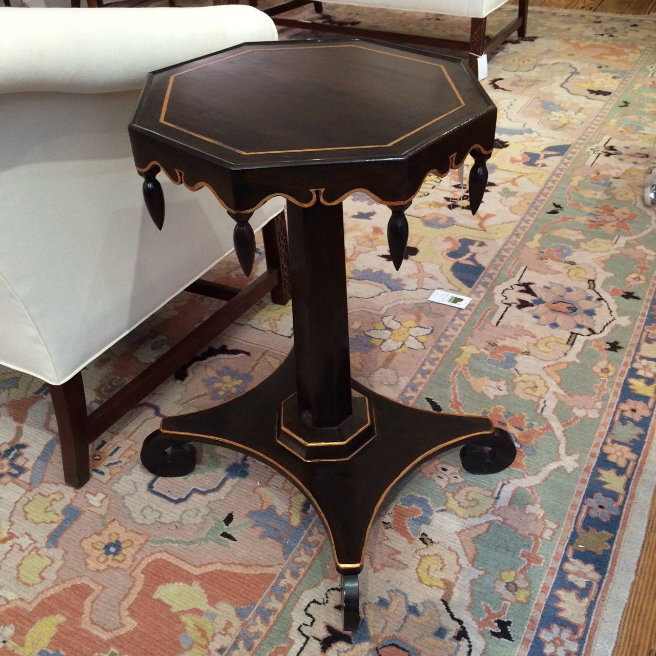 Very stylish black and gold wooden side table or drinks table, top is octagonal with scalloped decoration beneath and wooden tear drops. Base has curved feet and measures 28 x 28. Gold leaf detailing.