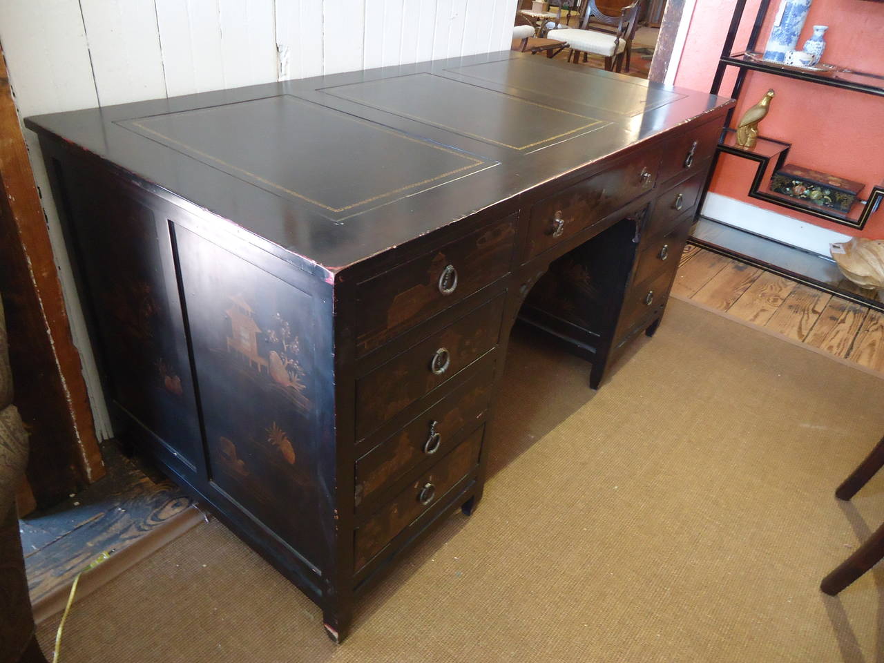 Handsome Mid-Century Japanned and chinoiserie kneehole desk. Decorated on all sides including the back (see last 4 photos) ; three inset leather panels with gold decoration; fretwork at kneehole.
Lends itself to free-standing use to enjoy every