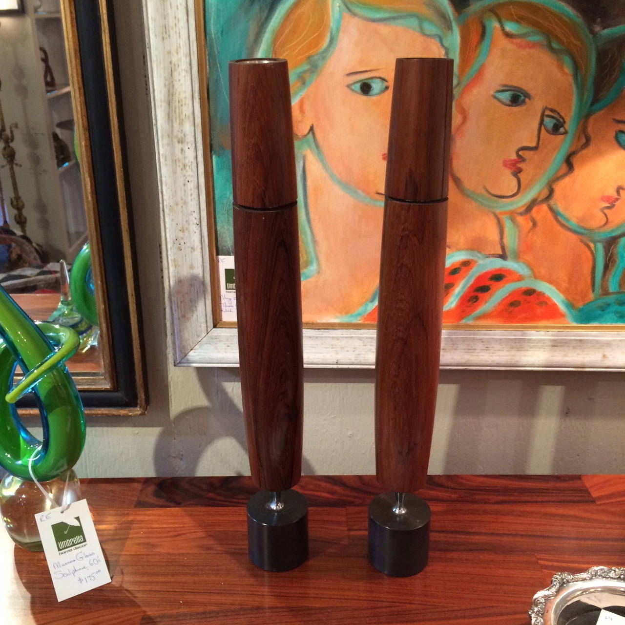 Sleek Rosewood Candlesticks, originally Ronson butane was used to fill up the inner chambers, then the top was turned to light flame.  Base is solid steel with a gun metal patination.  Labeled and dated on the underside.  Like abstract sculptures.
