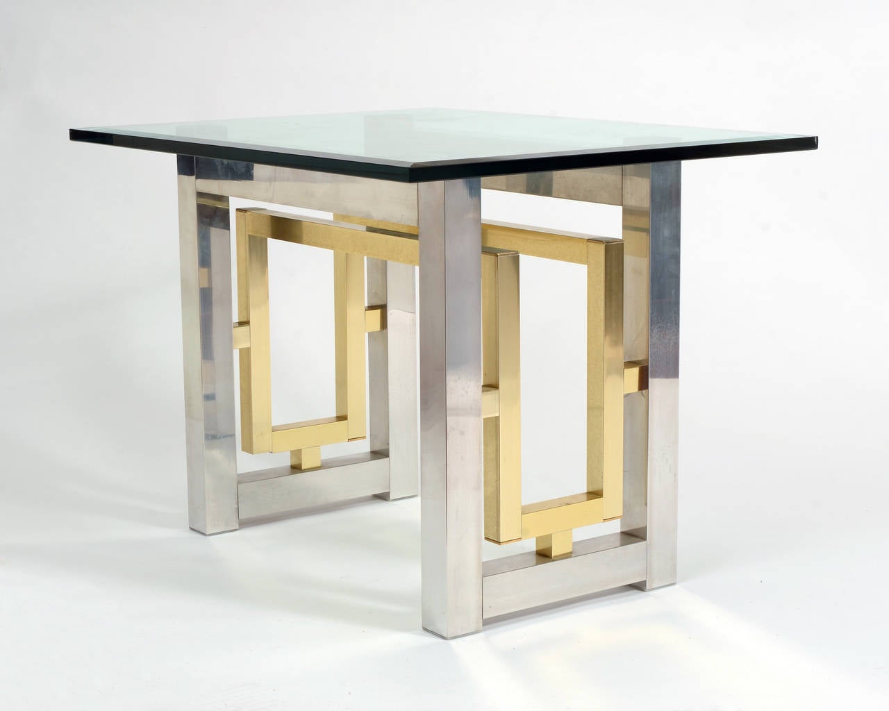 Stylish pair of end tables having a mix of chrome and brass in a geometric Mid-Century Modern design.
Bevelled glass tops are not included.
