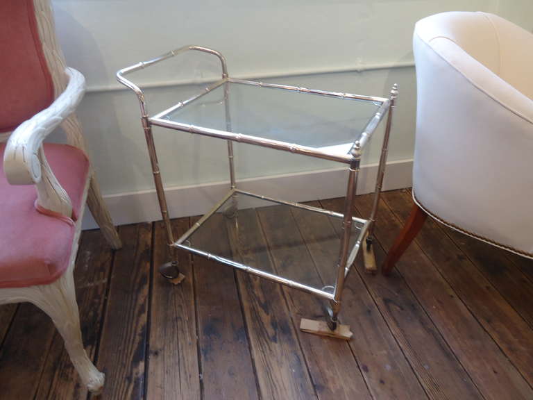Diminutive bar cart, silver plate faux bamboo Hollywood Regency style.
Wheels are especially nice.
26