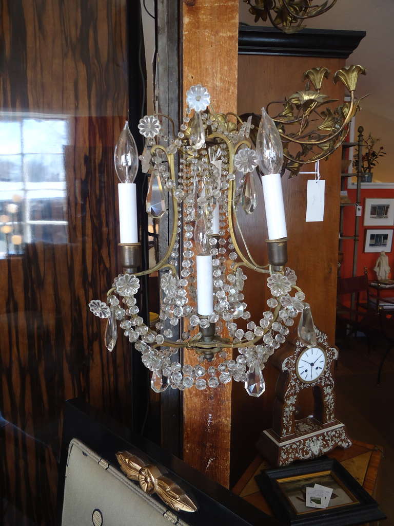Pair of beautiful antique four-light sconces with crystal bead swags and prisms; French; 1920s; newly wired.