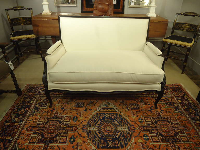 Newly recovered in white duck, a sophisticated loveseat with ebonized mahogany frame, window pane back, original finish. Just redone, seat cushion is down filled and comfy.