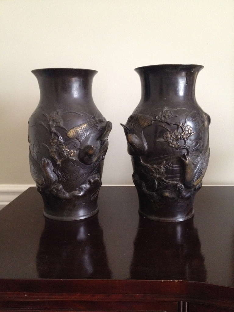 A beautiful pair of Japanese bronze vases with Phoenix birds, branches and floral relief incised into the vases.

Diameter at Base: 5