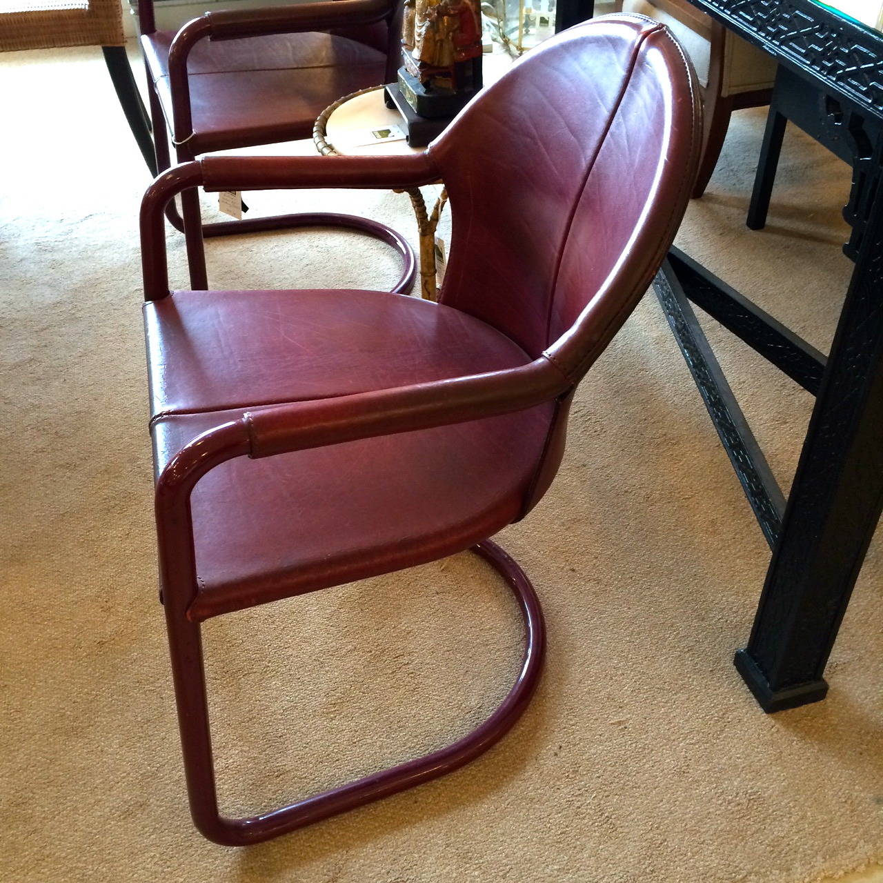 Handsome foursome of armchairs in stitched reddish brown leather, painted aluminum arms and base in matching color.  Textured seam up the backs.
Afew minor imperfections as seen in photos that add to the character and don't effect the comfort or