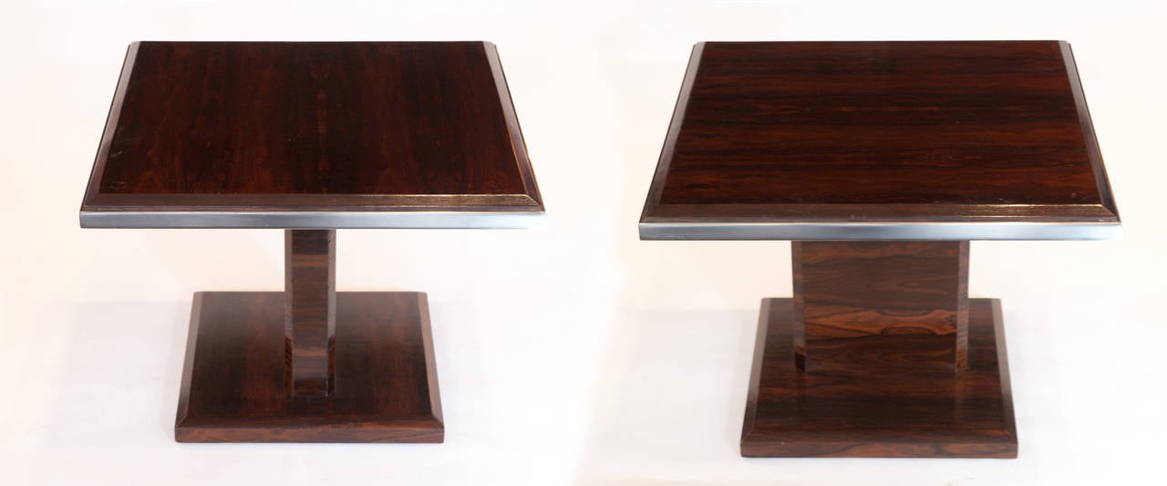 Two square cocktail tables having gorgeous rich rosewood veneer with chrome trim and glass tops.