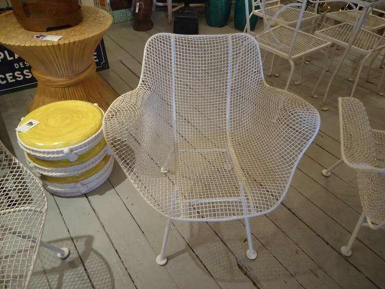 Iconic midcentury design by Russell Woodard, white mesh and iron legs.