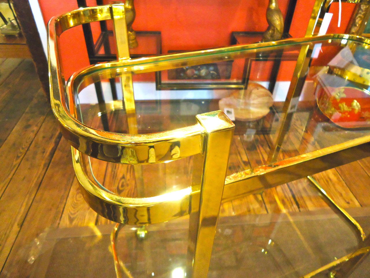 Solid construction, two tier brass and glass bar cart on casters.