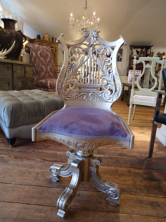 Lovely and functional early 19th century antique music chair; has just been silver leafed and covered in a plush purple velvet, adjustable...would make a fabulous desk chair.
