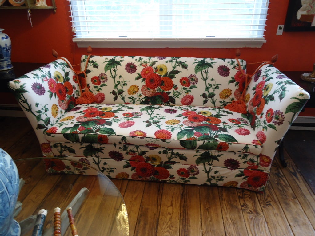 Knole style loveseat covered in gorgeous poppy adorned Lee Jofa fabric;  4 burnt orange wooden finials with cords and tassles;  excellent condition
74