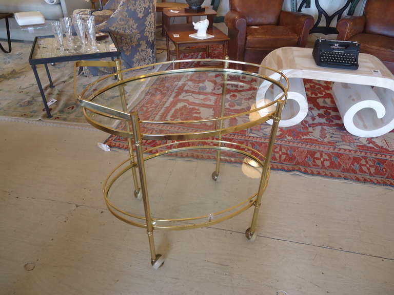 Simple elegance, two oval glass levels, brass handle can be attached on either side, rolls easily on 4 casters .