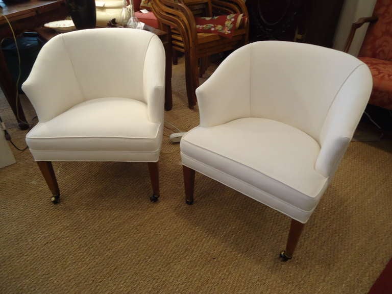 Very versatile size, small and tailored sophisticated occasional chairs, newly recovered in heavy gauge white duck.  On brass casters.