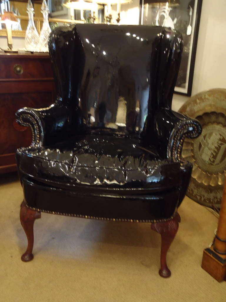 Glamorous and fun, vintage wing chair in 1970's shiny black patent leather and brass nailheads, Queen Anne legs