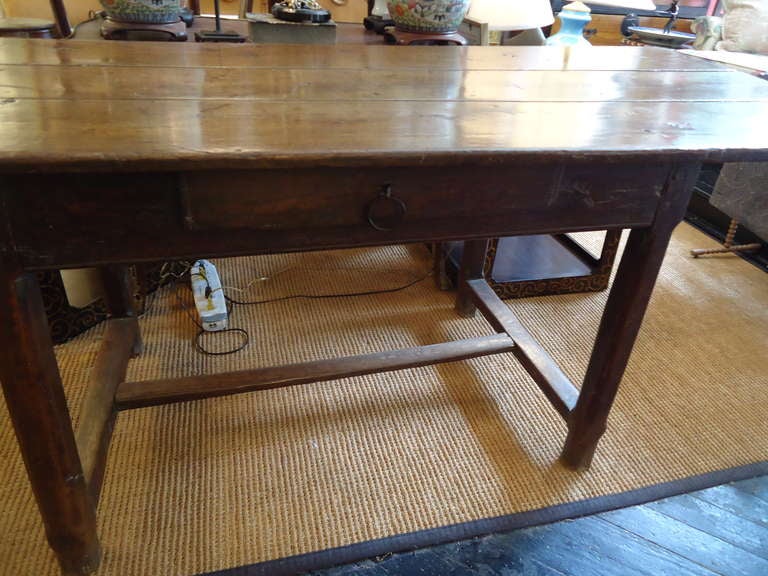 Loaded with character and old world charm, French Provincial elm table, could be used for dining or a wonderful long desk with one drawer.  (Sofa back table too!)  3 board top over apron on chamfered legs connected by H stretcher.