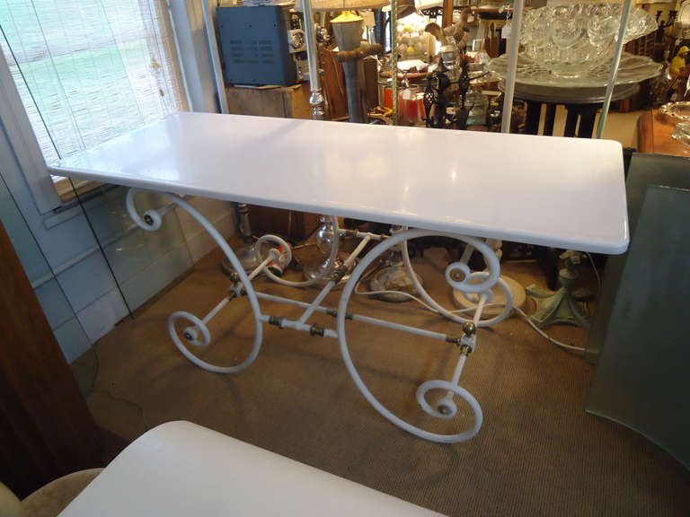 Base is scrolly white painted iron with brass embellishments.  Top is a rectangular piece of smooth milk glass.  Wonderful in a kitchen.