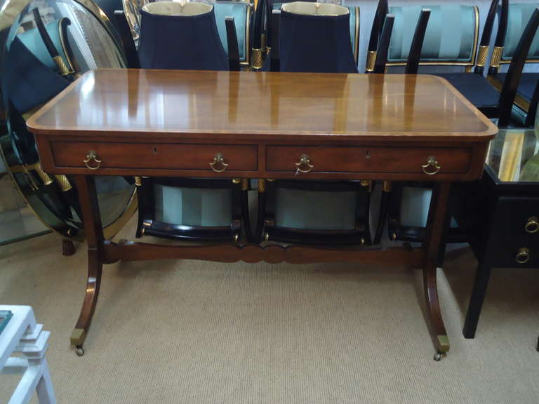 Classically traditional mahogany inlaid with satinwood writing desk, bronze casters.  
25