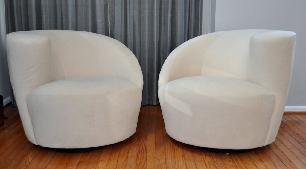 Stunning pair of Nautilus Swivel Lounge Chairs designed by Vladamir Kagan for Weiman, which produces many of Kagan's designs to this day.  Beautiful neutral Ultra Suede.
Swivel base with automatic return.  Pair includes one left and one right