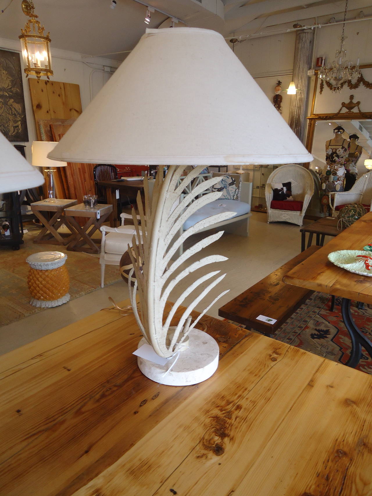 Stylish palm frond inspired lamps, painted metal with ivory/beige travertine bases and matching round finials. Bases are 8