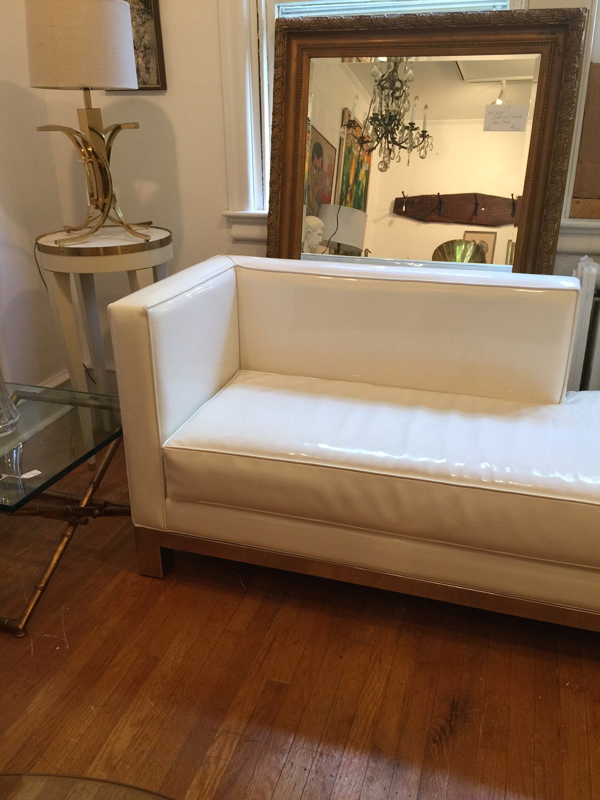 Sleek vintage rectangular loveseat with chrome base having
one seat cushion.  White patent leather in good vintage condition.