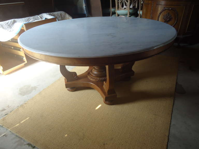 Beautiful hard wood base, probably teak.  Empire style, large round off white marble top.  Has some circular marks, which should come out with minor restoration.
