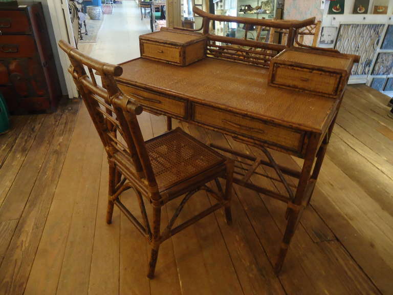 Wonderful vintage desk and chair with Asian flair, faux bamboo, rattan and hand caned chair.  Beautiful workmanship.
Chair seat height 17.5