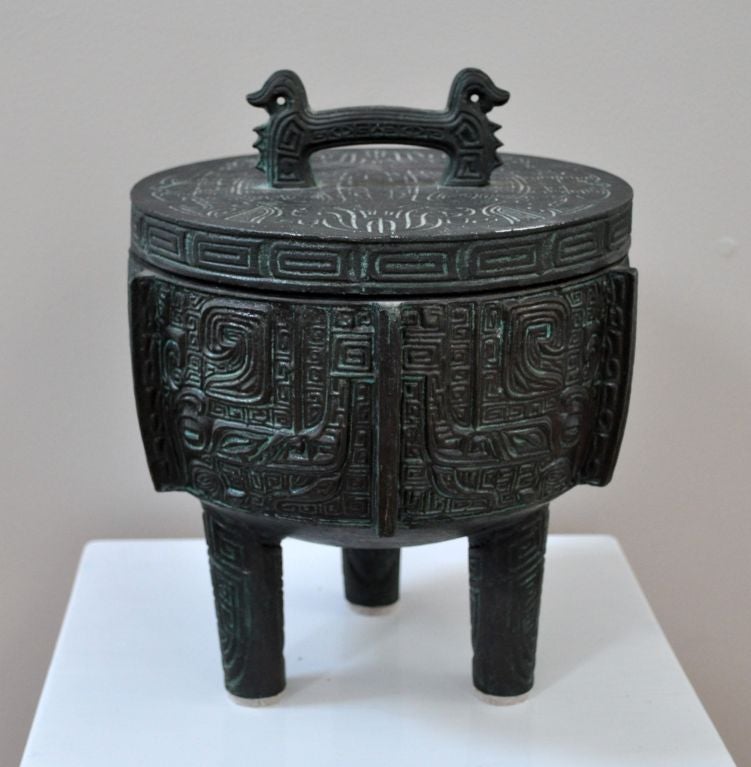 Ice bucket, cast copper with Asian motifs.