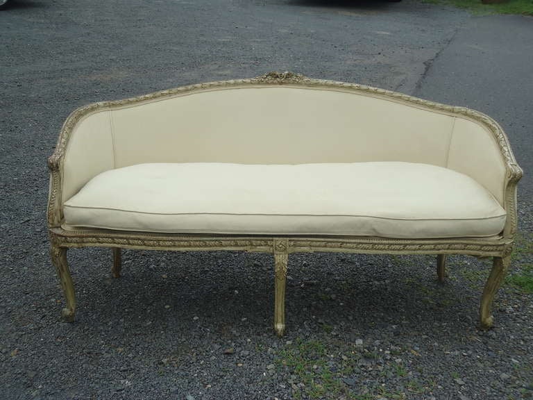 Lovely carved wood and upholstered loveseat, needs to be recovered but down cushion and original patina on wood.
Perfect size at the end of a kingsize bed.  Circa 1880
Seat depth 23
