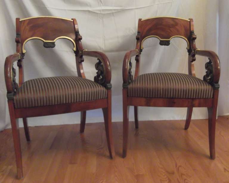 A gorgeous pair of Baltic Russian Neoclassical Parcel Gilt and Painted Mahogany Armchairs, Circa 1810.
The finely carved scrolling arms are highlighted with paintwork resembling dark patinated bronze.
23.5