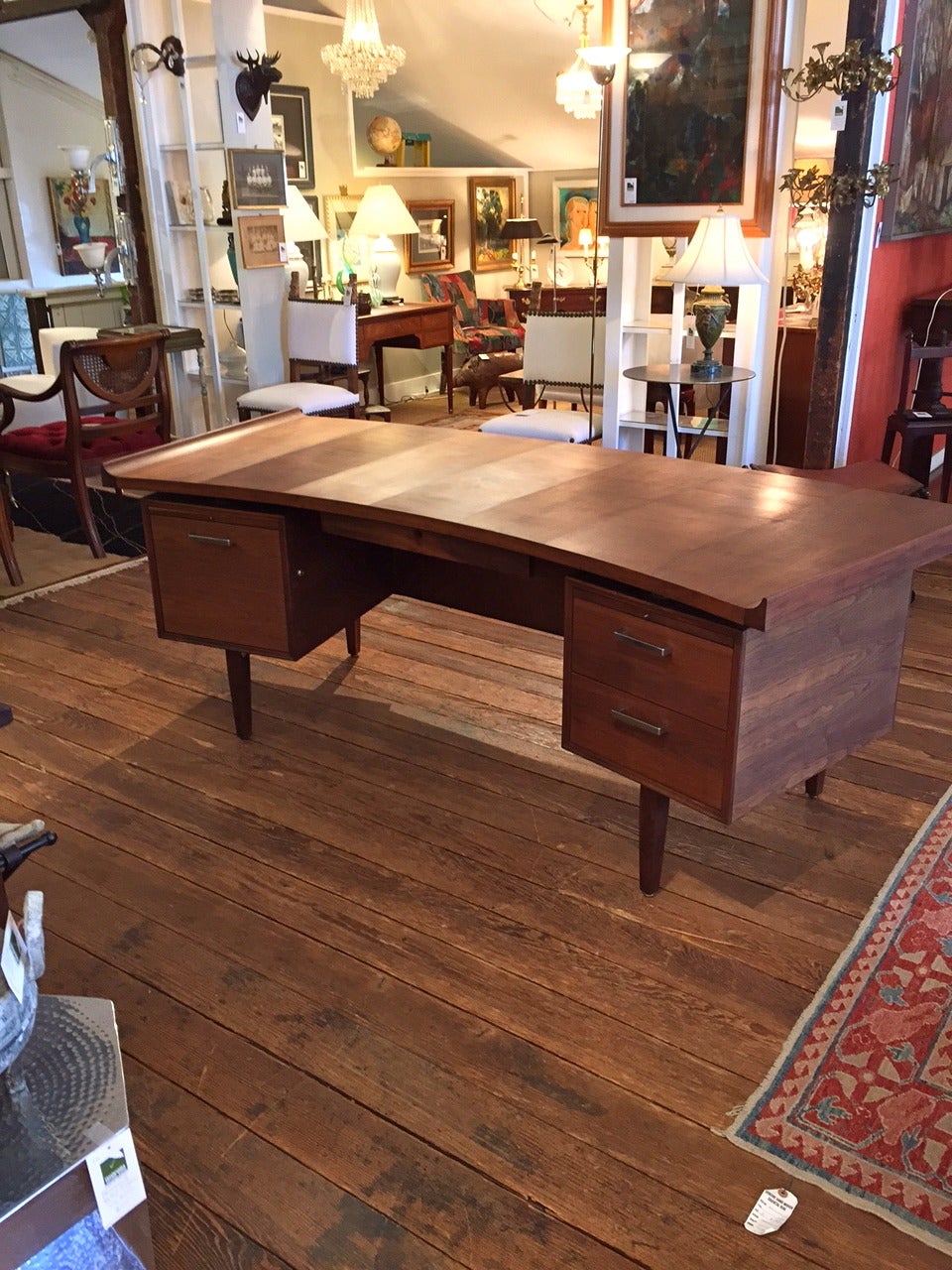 Mid century modern walnut desk with curved parquetry top that sits on double bank of drawers.  Rounded front, with gorgeous decorative woven wood on front under rounded writing surface.   Danish in style.